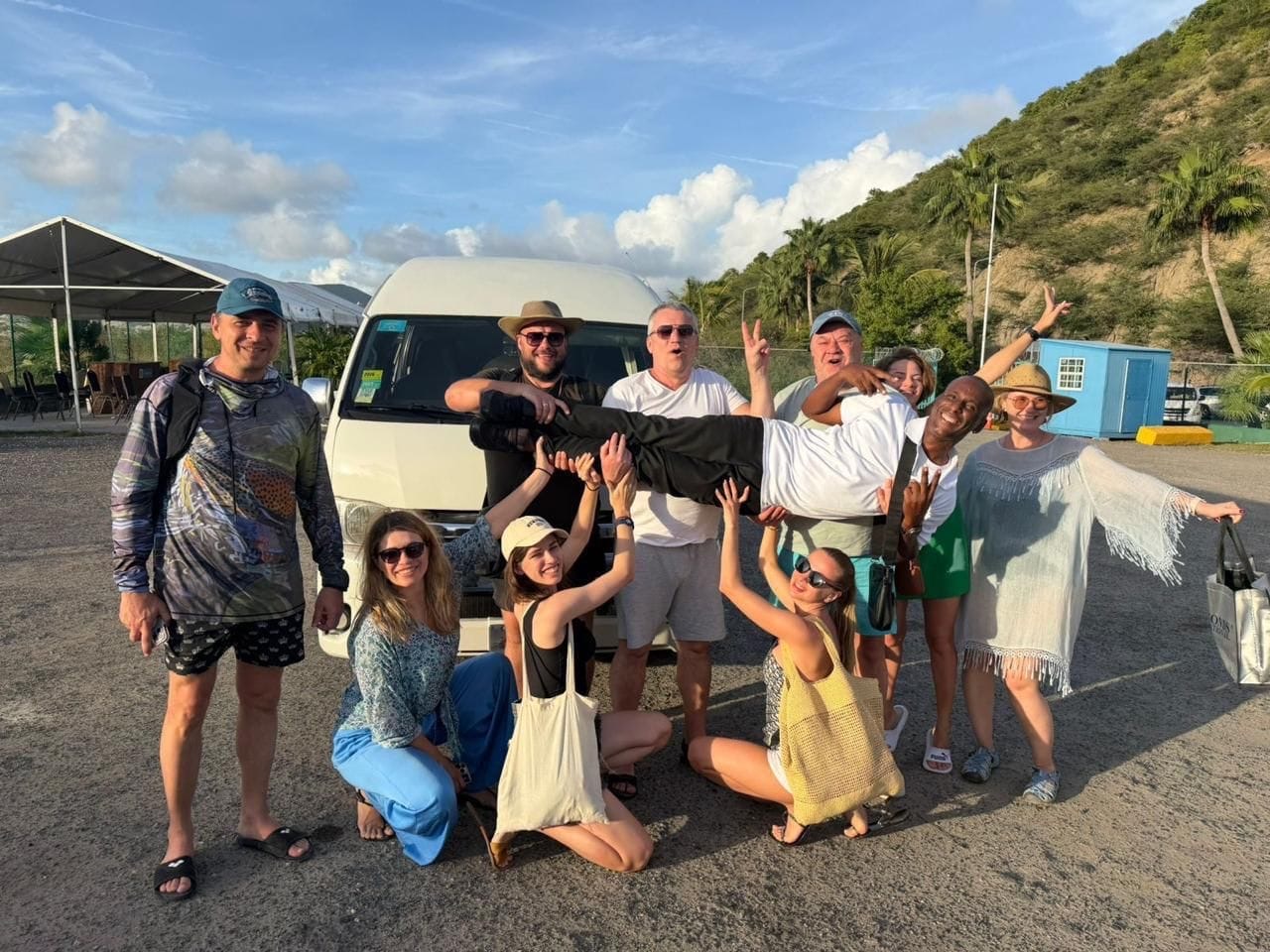 Andy with happy guests in front of the white Toyota HiAce, Sint Maarten